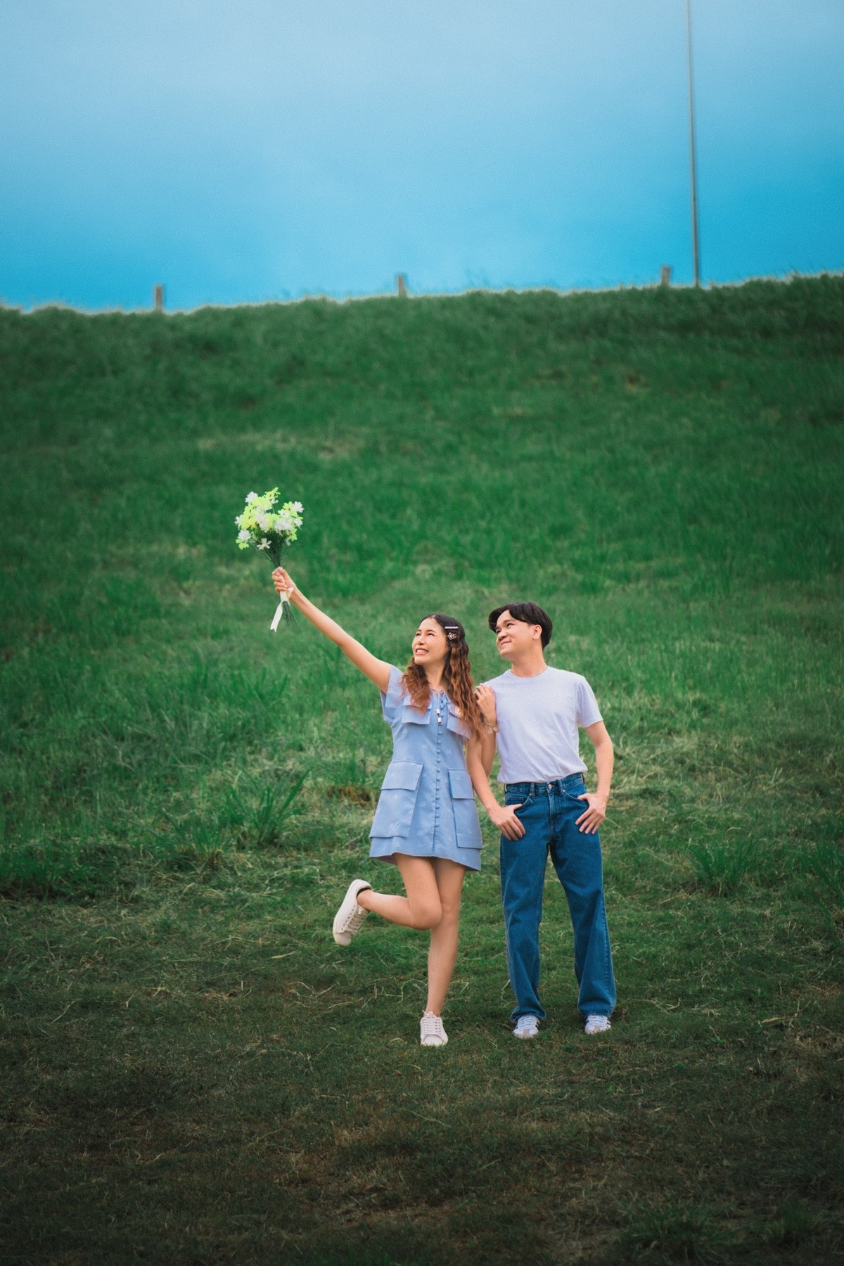 Amm and Hrung celebrating on the green hillside